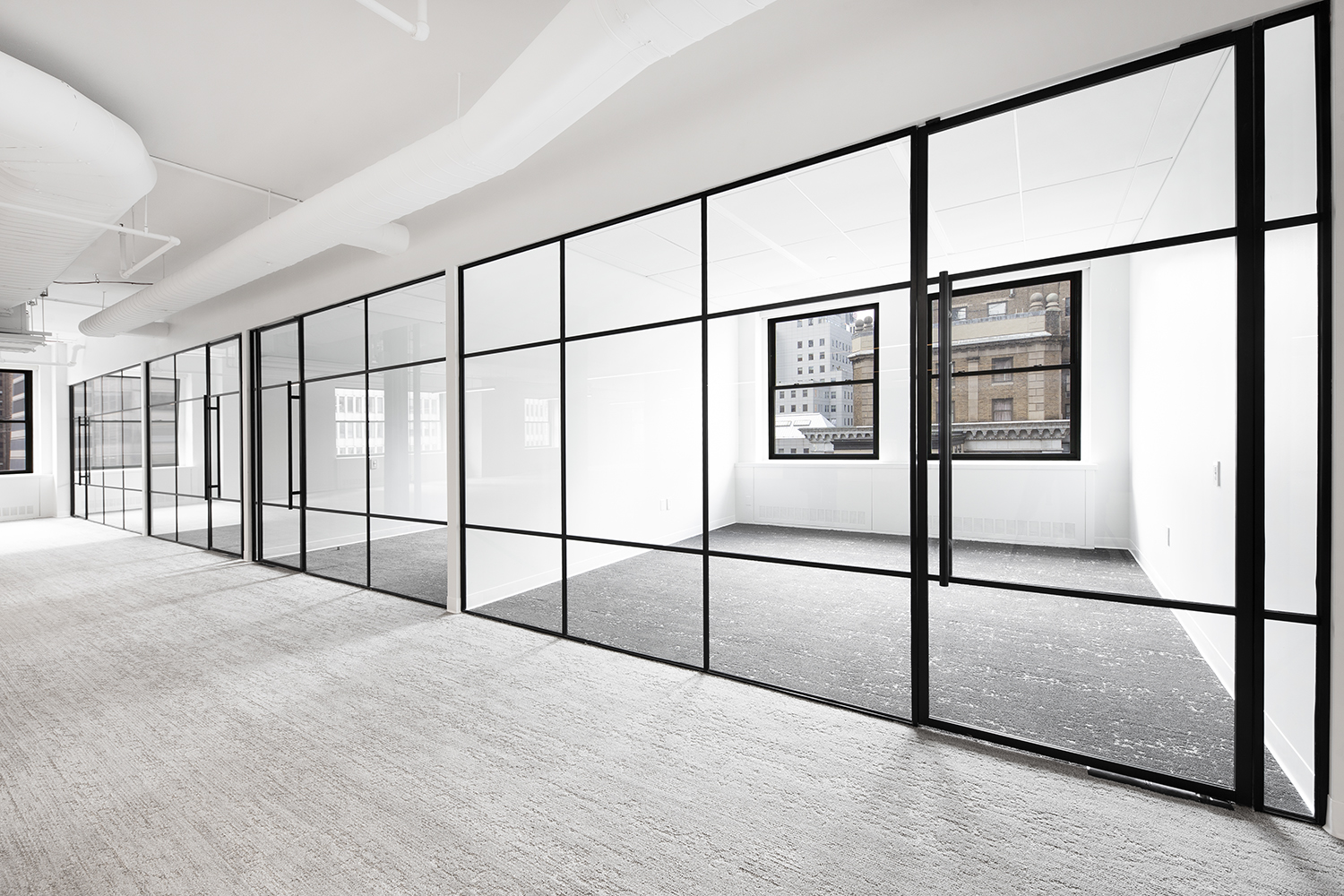 Contemporary office interior defined by black steel and glass