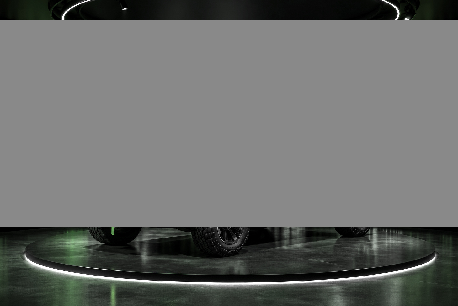 Real-time animated artwork surrounding a vehicle in an automotive pavilion